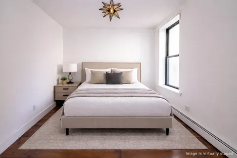 a bedroom with a bed and window