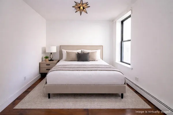 a bedroom with a bed and window