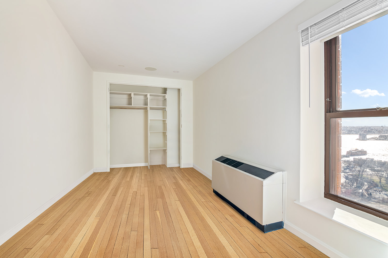 20 West Street, Unit 28F Manhattan, NY 10004 - Photo 6 of 18 a view of a room with wooden floor and a window