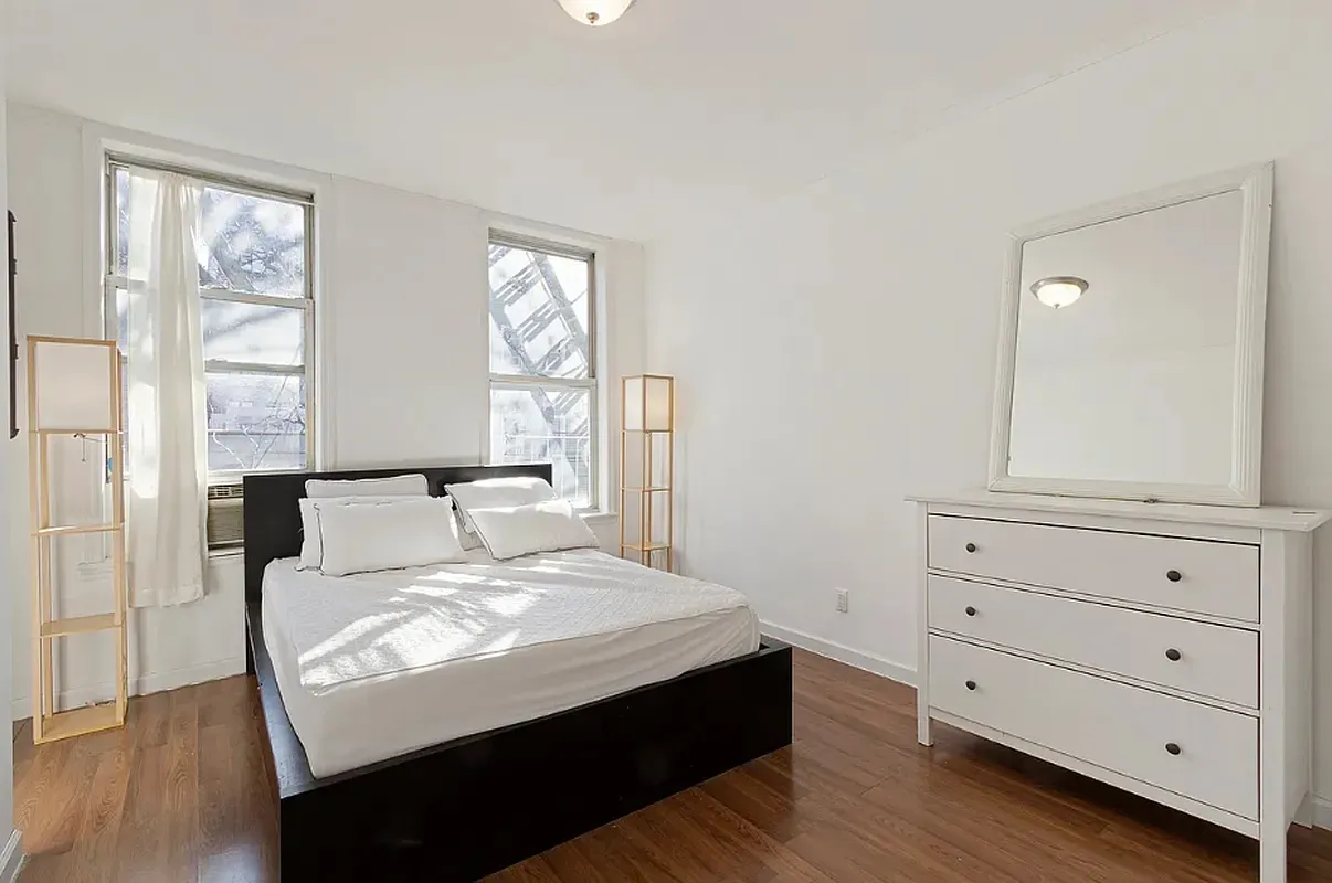 a large white bed in a white room
