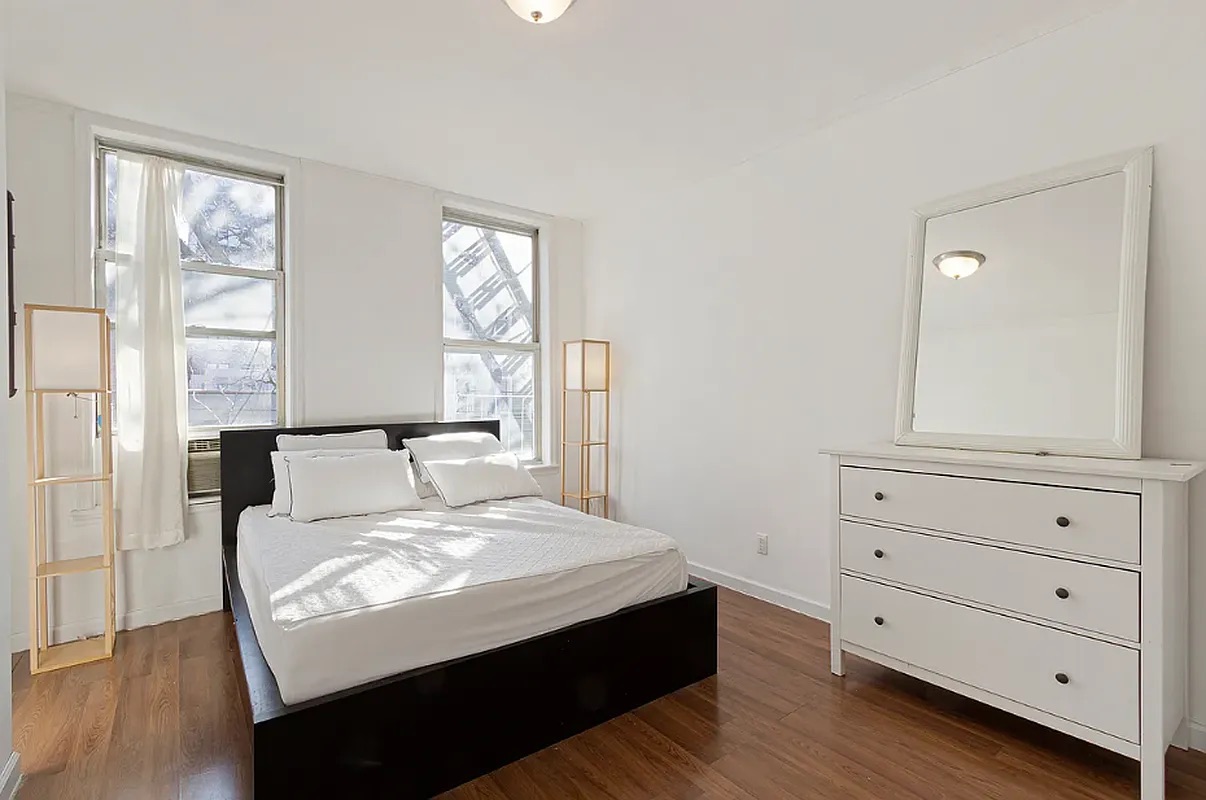 5-39 47th Road, Unit 2R Queens, NY 11101 - Photo 3 of 7 a large white bed in a white room