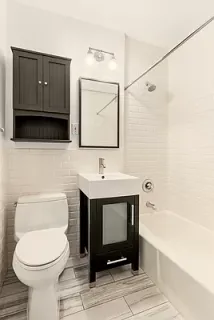 a bathroom with a toilet a sink and bathtub