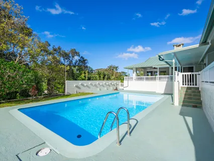 swimming pool view with a seating space