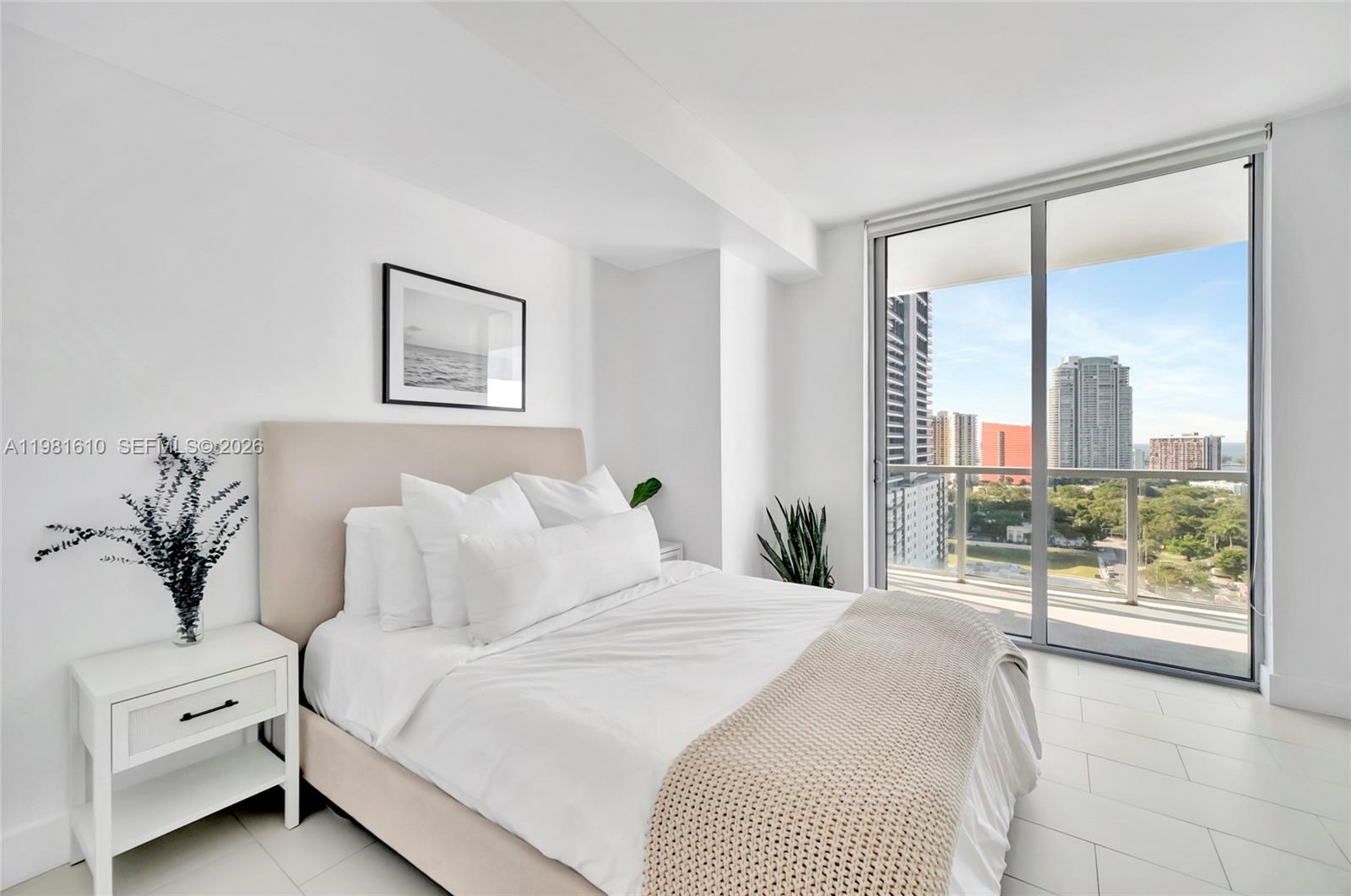 79 Southwest 12th Street, Unit 2201S Miami, FL 33130 - Photo 20 of 33 a bedroom with a large bed and a large window