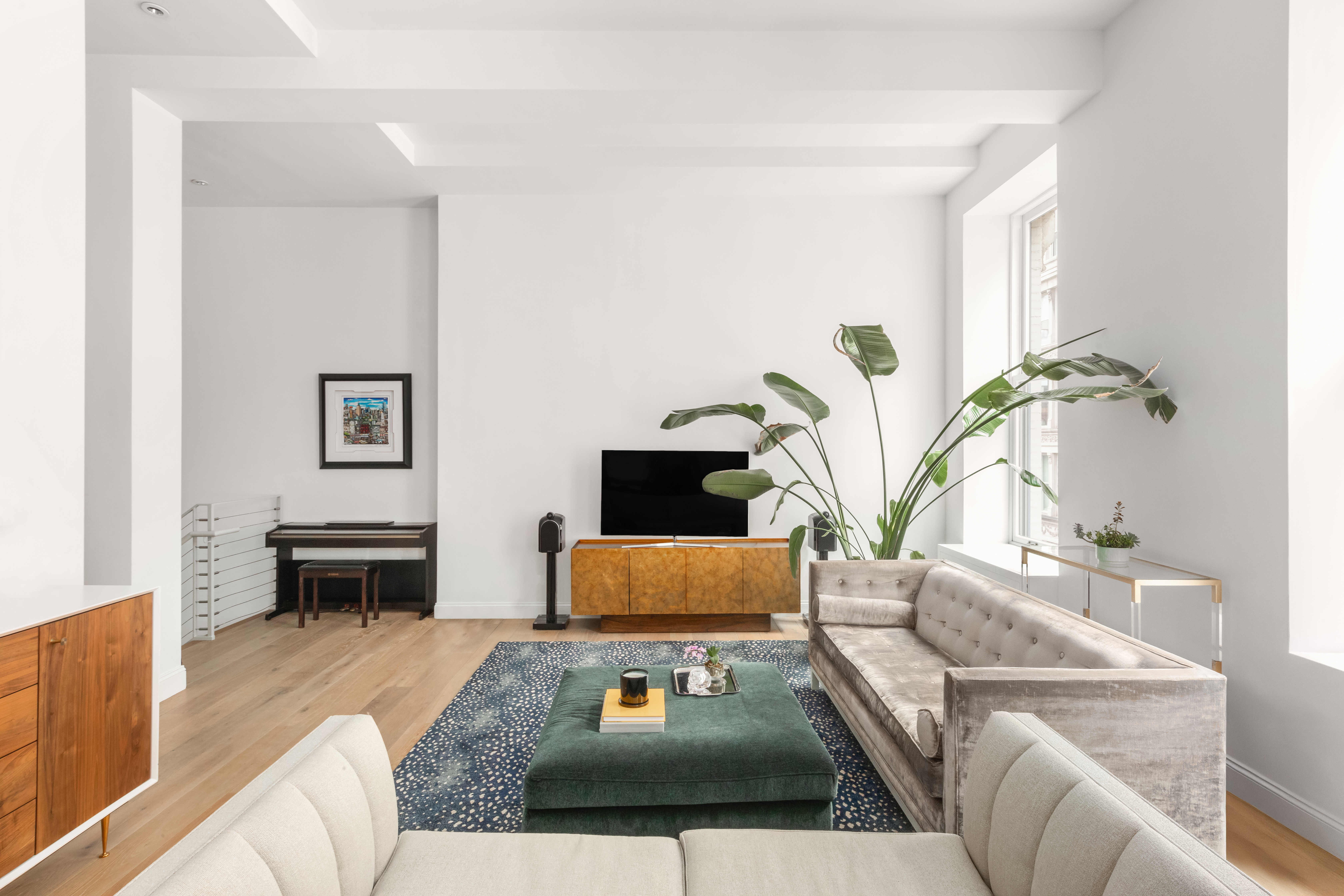 655 6th Avenue, Unit 5H Manhattan, NY 10010 - Photo 3 of 15 a living room with furniture and a flat screen tv