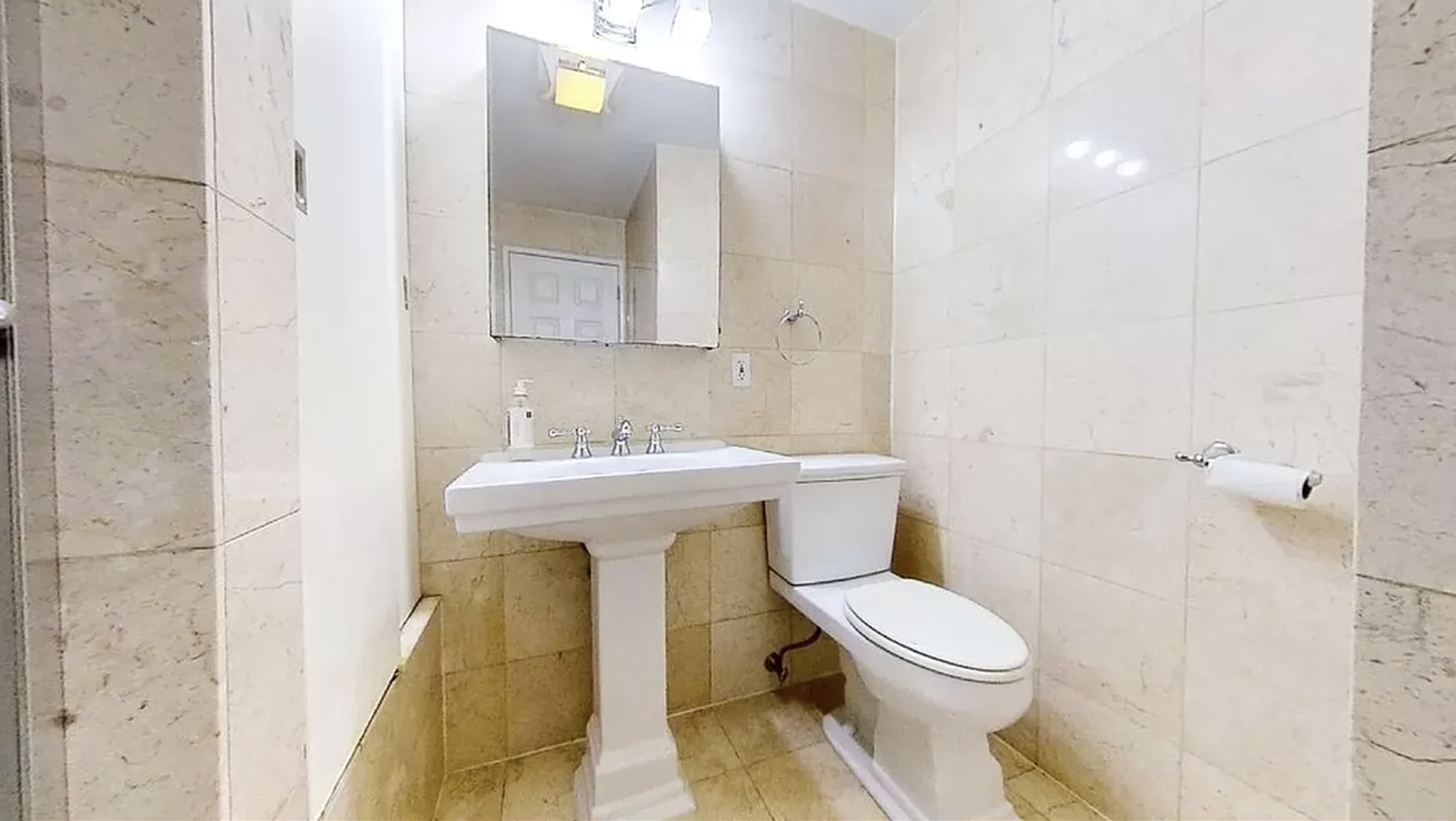 190 Meserole Avenue, Unit 2N Brooklyn, NY 11222 - Photo 8 of 10 a bathroom with a sink toilet and mirror