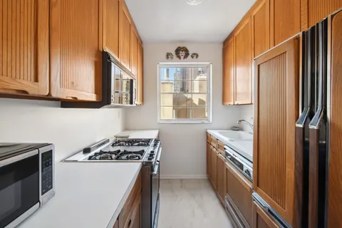 a kitchen with stainless steel appliances a stove a sink and a refrigerator