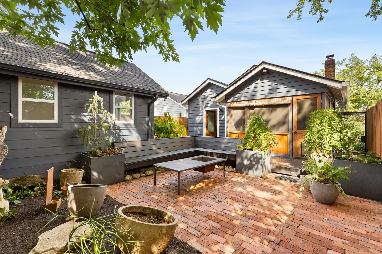 a view of a house with backyard and sitting area