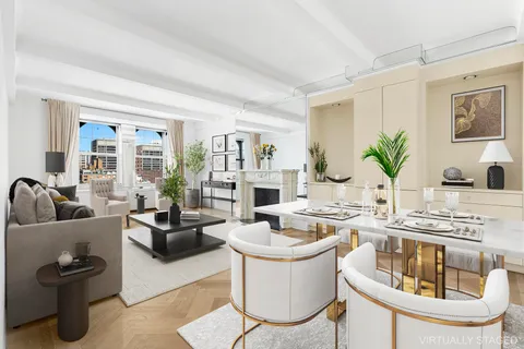 a living room with fireplace furniture and a potted plant