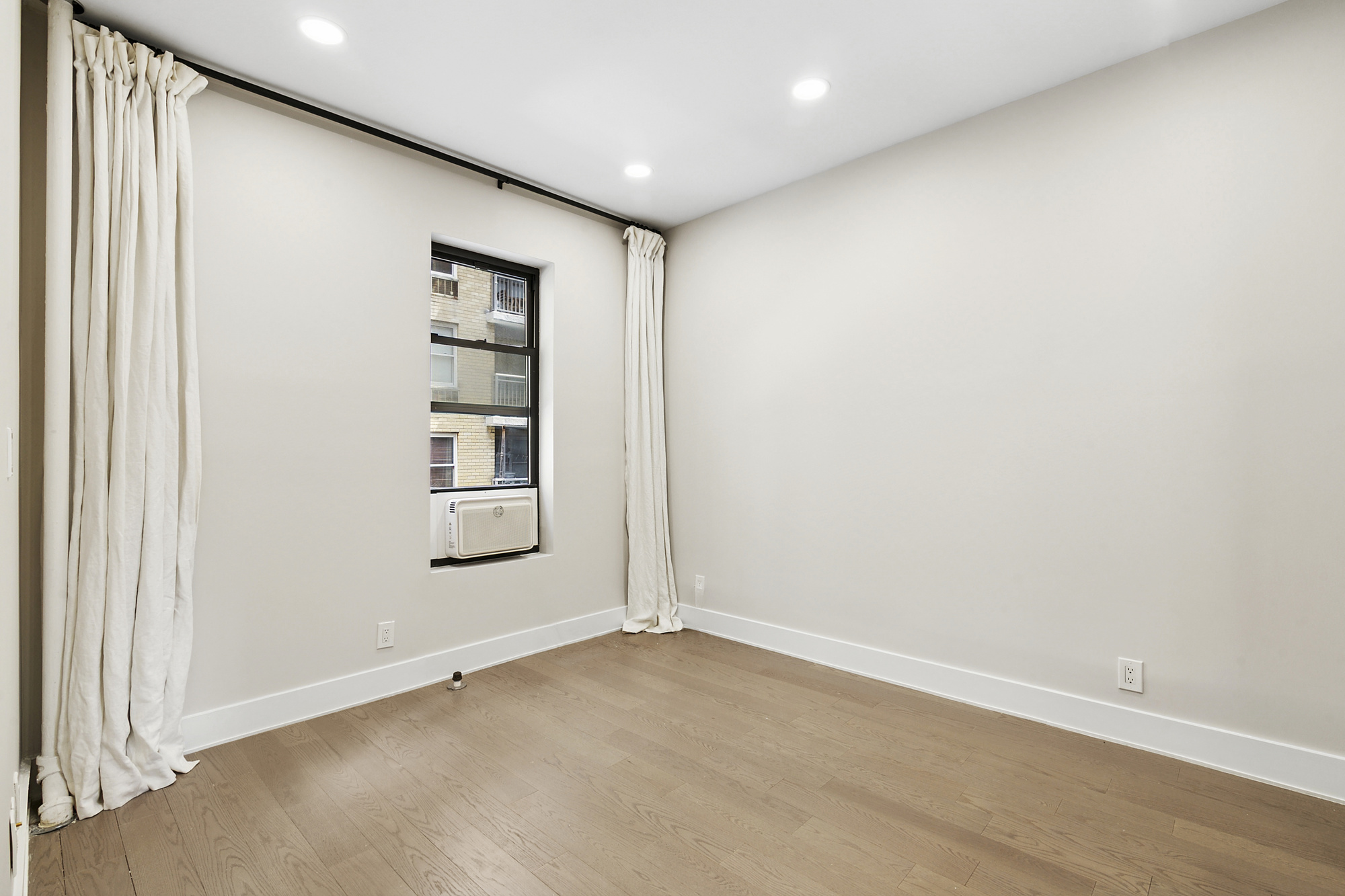 211 West 88th Street, Unit 2A Manhattan, NY 10024 - Photo 3 of 8 an empty room with windows