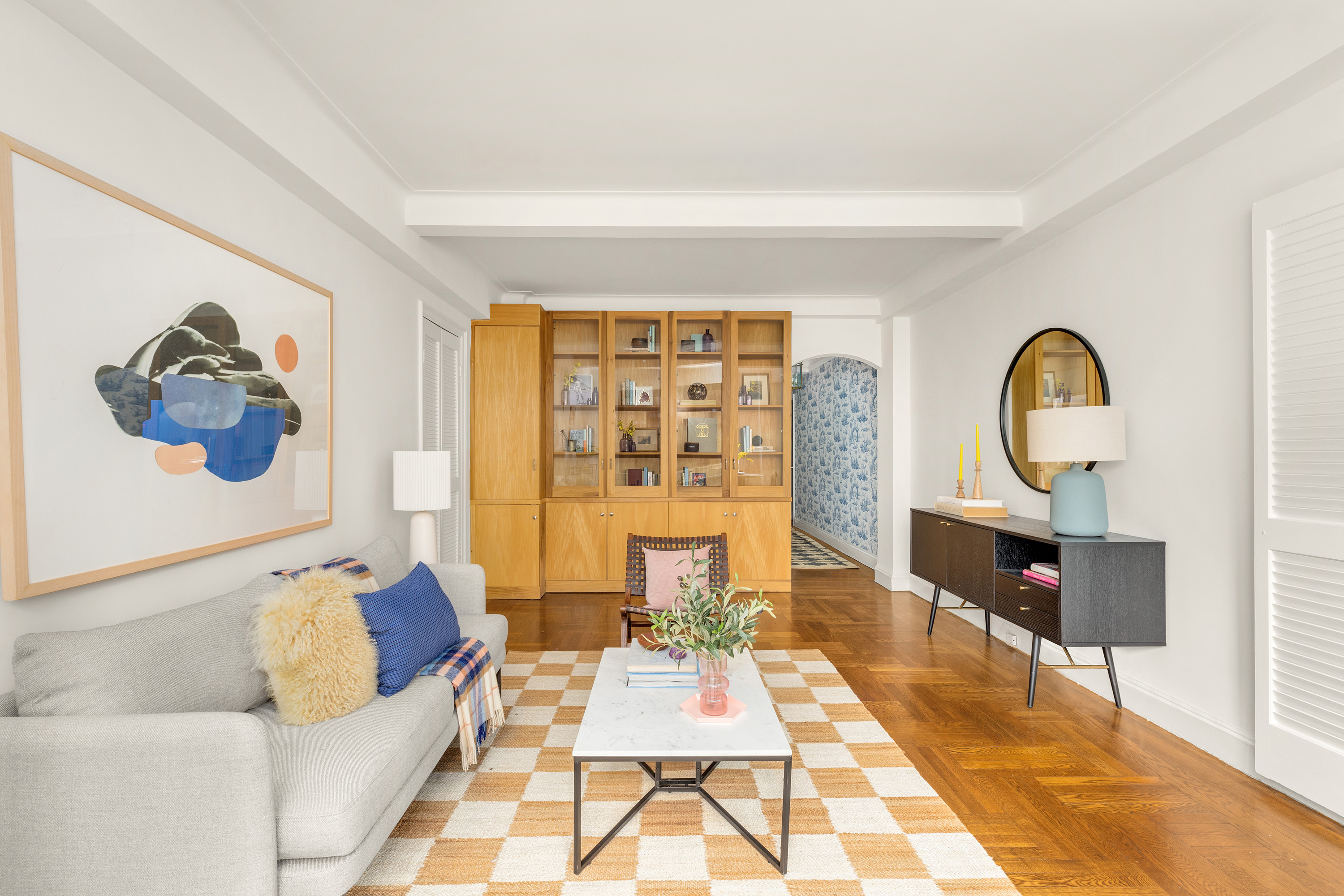 245 East 72nd Street, Unit 8G Manhattan, NY 10021 - Photo 4 of 10 a living room with furniture and a large window