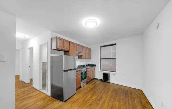 a kitchen with stainless steel appliances granite countertop a refrigerator and a stove