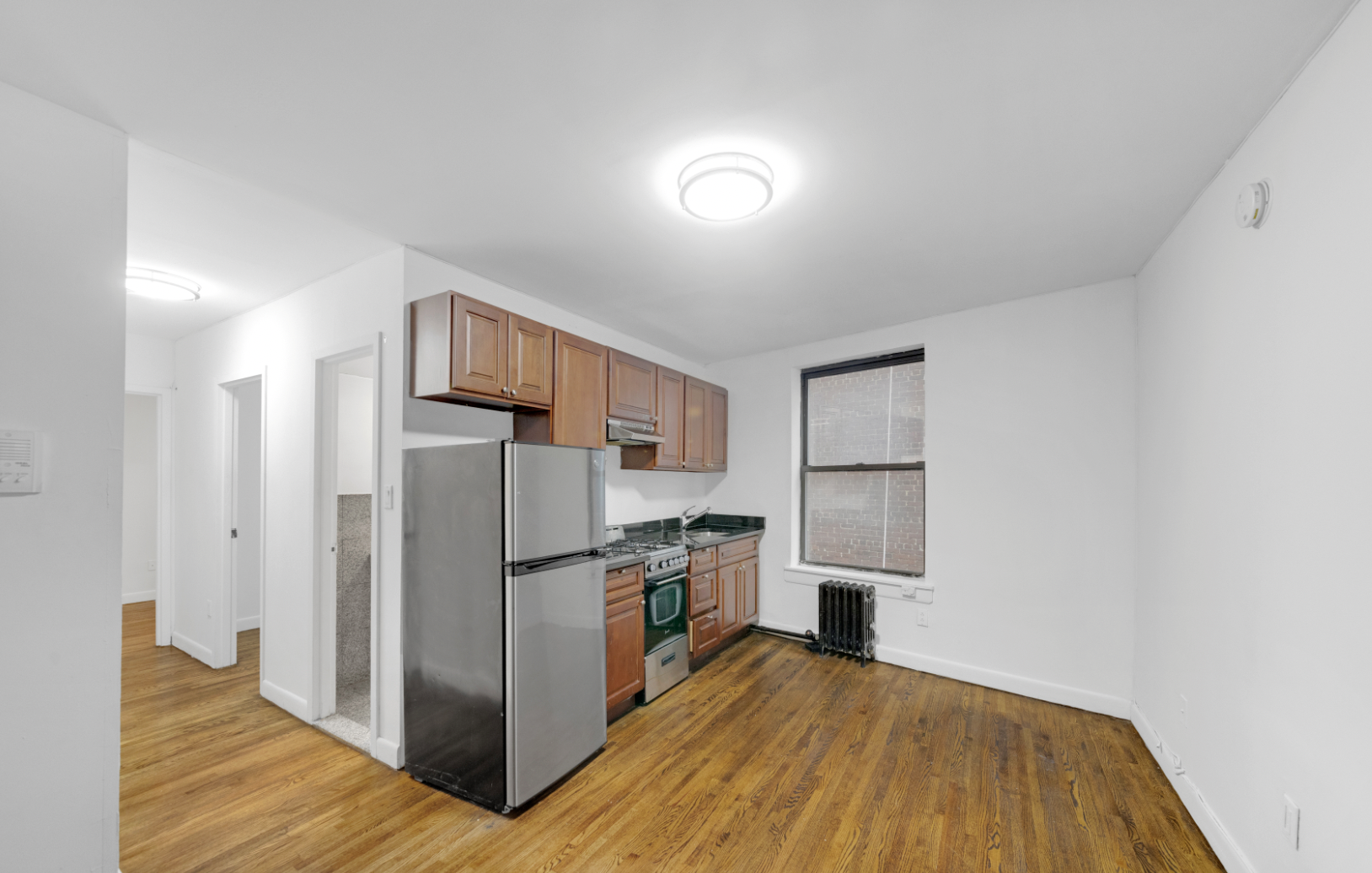 24 East 97th Street, Unit 21 Manhattan, NY 10128 - Photo 1 of 5 a kitchen with stainless steel appliances granite countertop a refrigerator and a stove