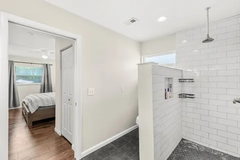 a bathroom with a toilet a sink a mirror and vanity