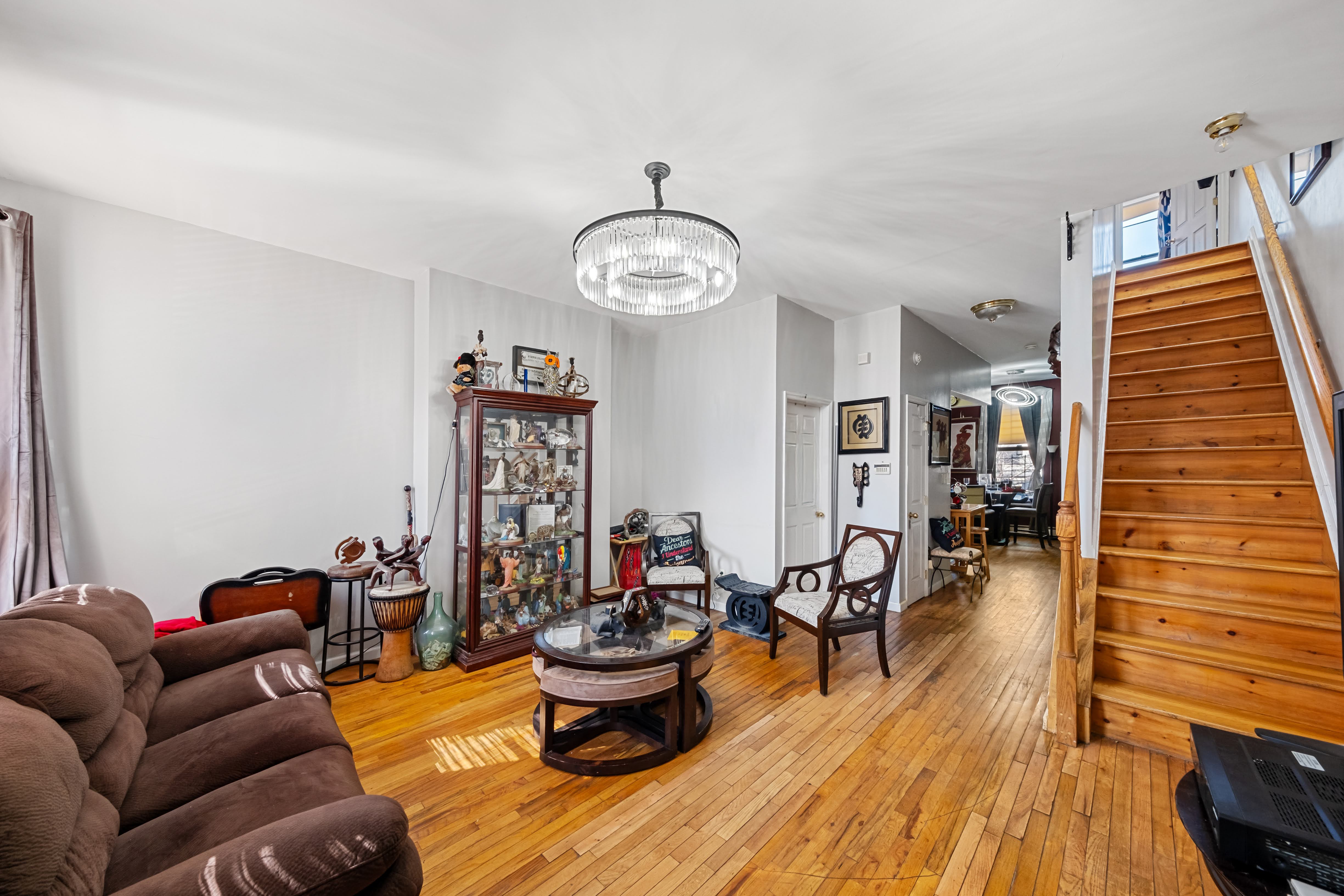 275 Van Buren Street Brooklyn, NY 11221 - Photo 2 of 33 a living room with furniture a piano and wooden floor