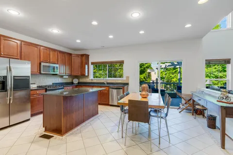 a large kitchen with lots of counter space and furniture