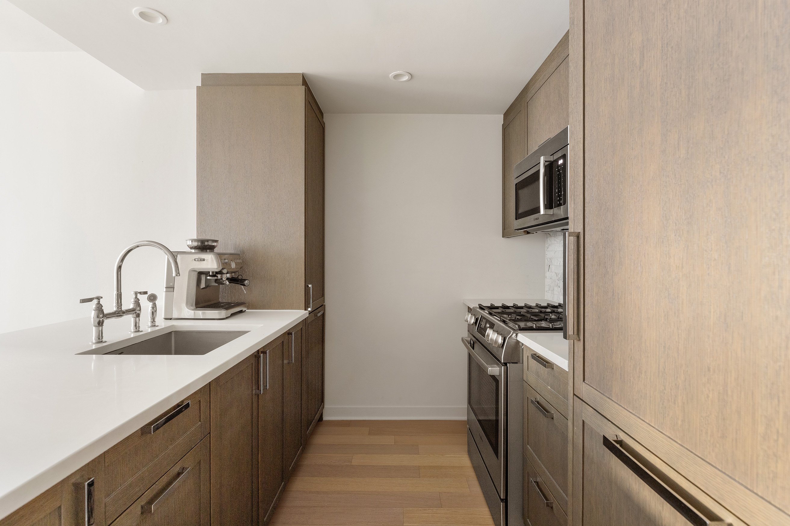 261 Hudson Street, Unit 5S Manhattan, NY 10013 - Photo 2 of 6 a kitchen with a sink and a stove top oven