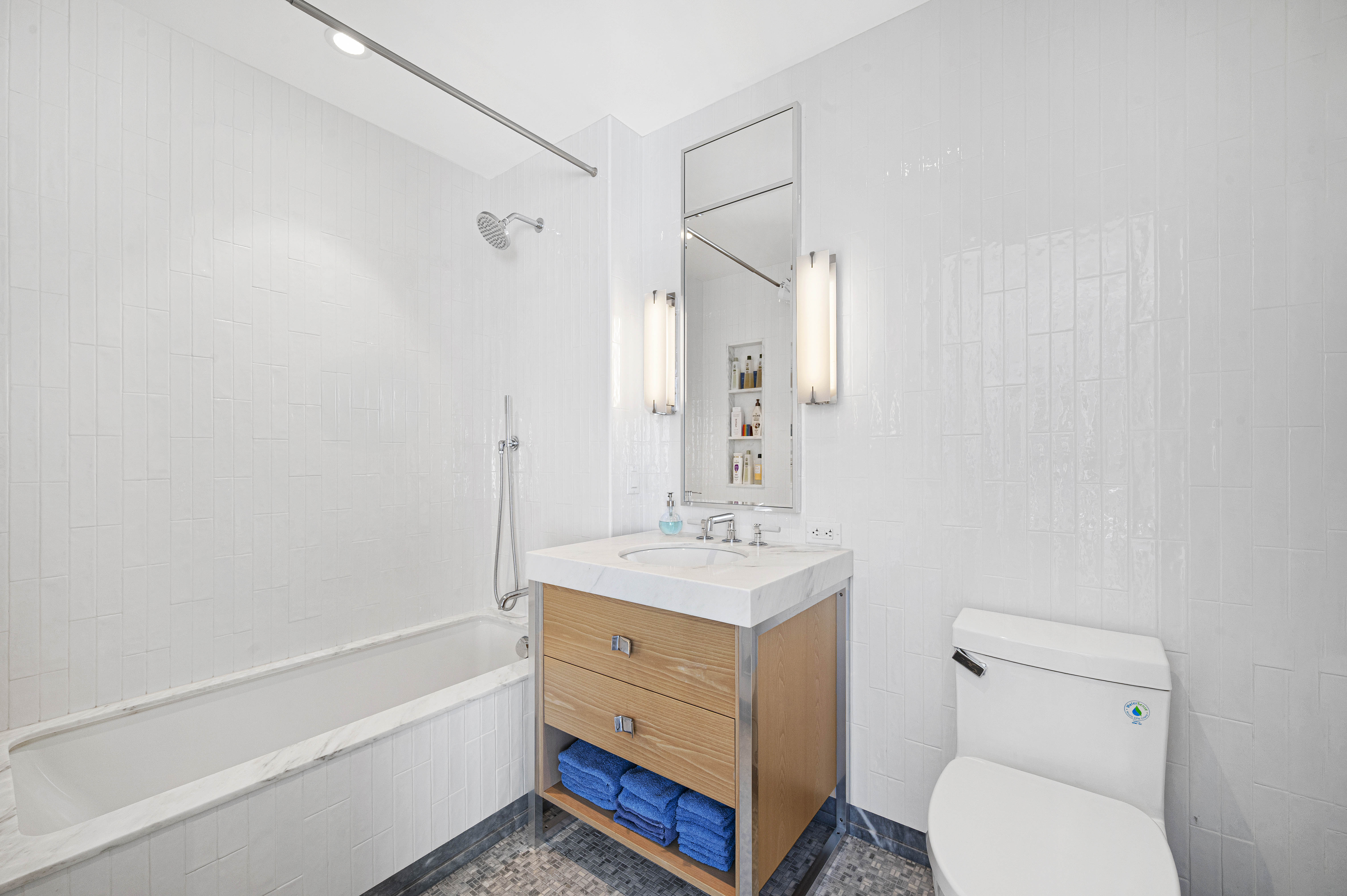 368 3rd Avenue, Unit 11A Manhattan, NY 10016 - Photo 10 of 17 a bathroom with a sink a toilet and shower