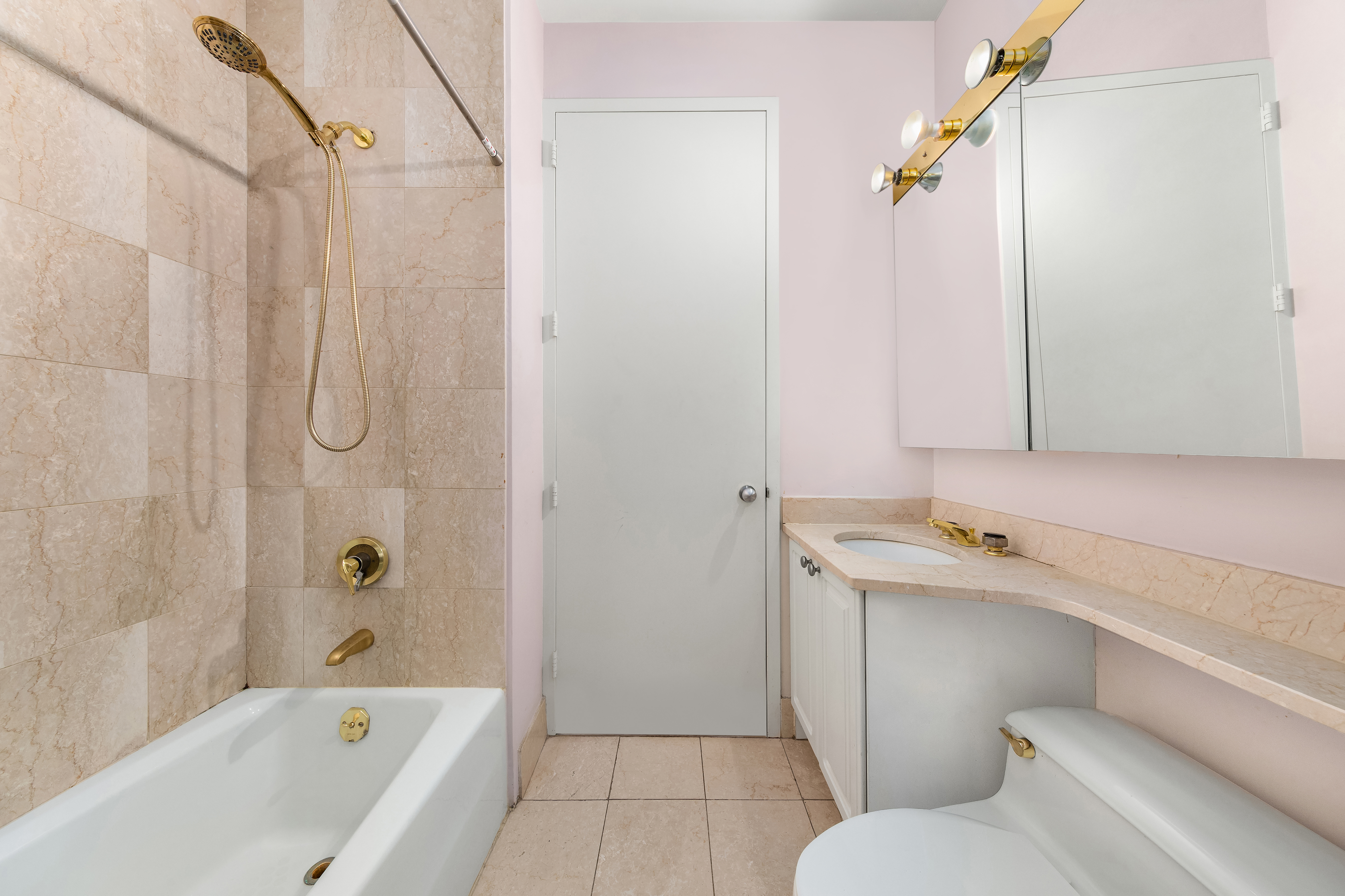 120 East 87th Street, Unit P28B Manhattan, NY 10128 - Photo 4 of 8 a bathroom with a sink a toilet and shower