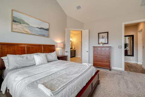 a bed room with a bed and a chandelier