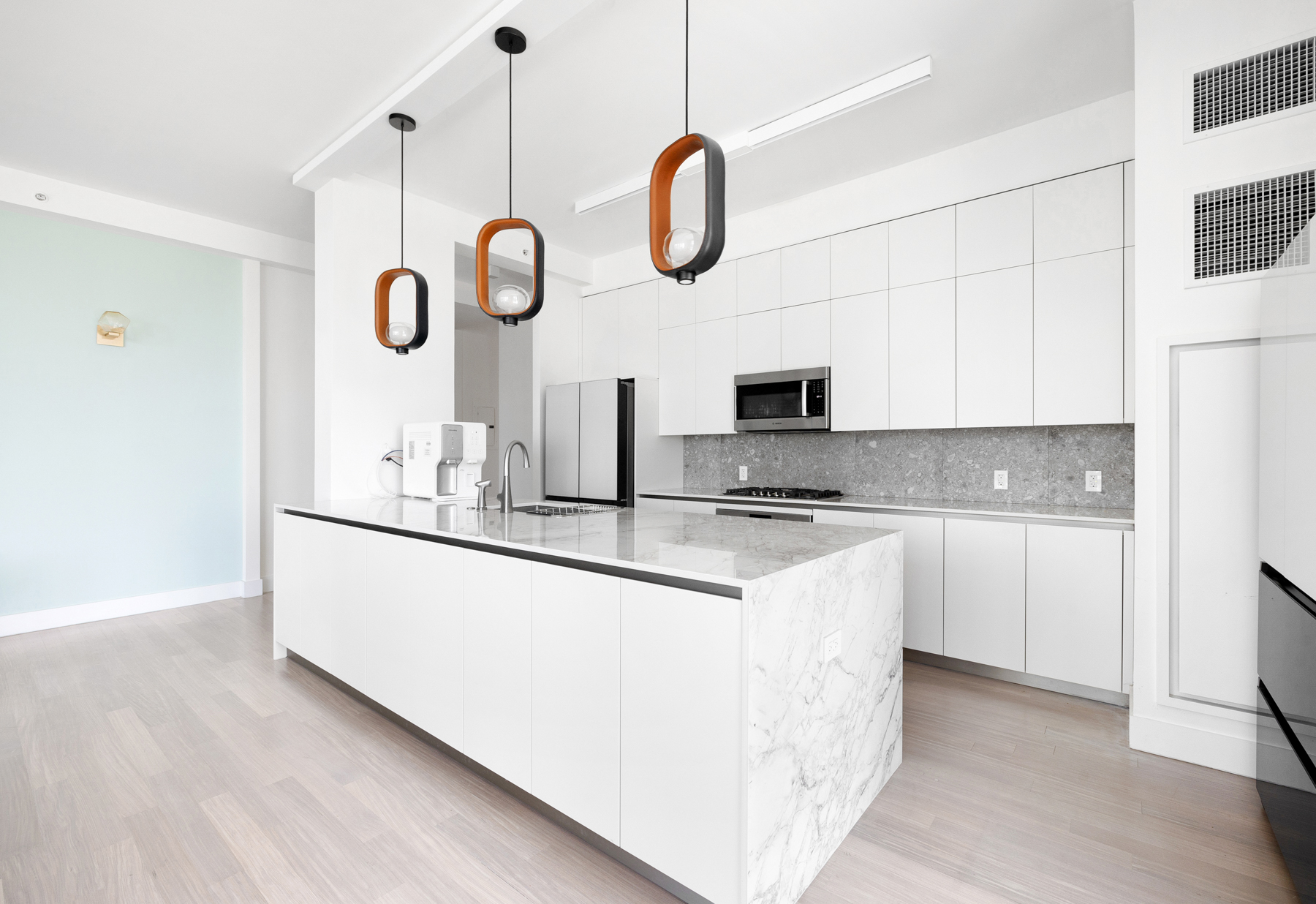 10 West End Avenue, Unit 30C Manhattan, NY 10023 - Photo 7 of 22 a kitchen with stainless steel appliances granite countertop a sink a stove and a wooden floors