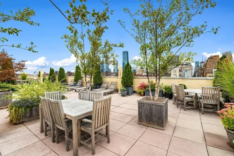 a view of a patio with dining table and chairs with plants