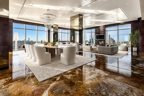 a living room with fireplace furniture and a large window