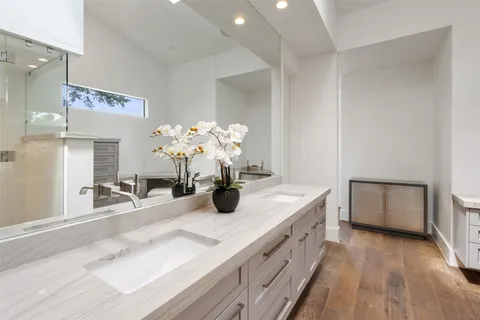 a bathroom with a double vanity sink and a mirror