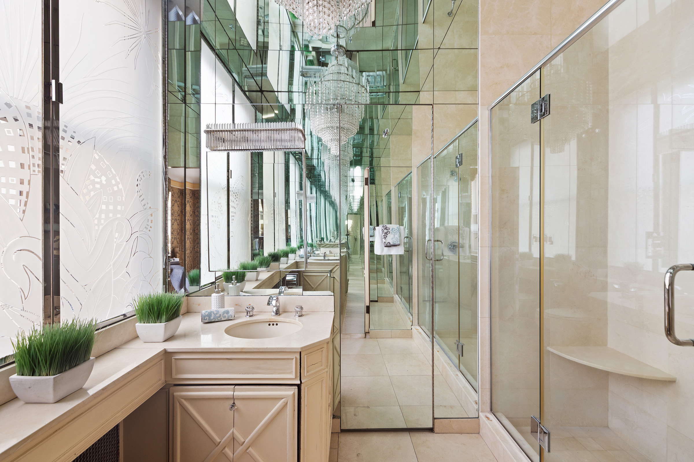 31 East 72nd Street, Unit 4B Manhattan, NY 10021 - Photo 7 of 14 a bathroom with a granite countertop sink a mirror and shower