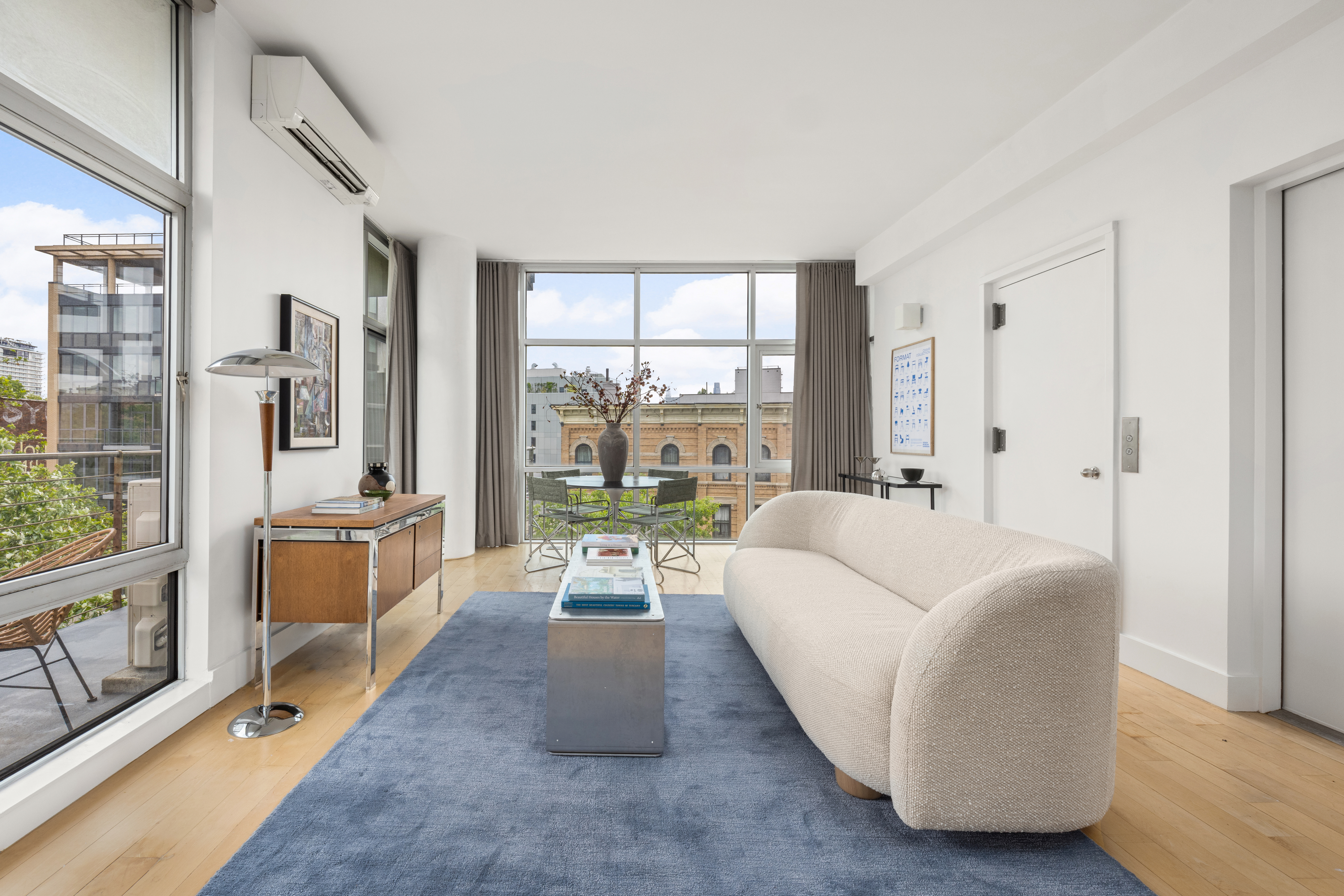 297 Driggs Avenue, Unit 4A Brooklyn, NY 11222 - Photo 3 of 9 a living room with furniture and large windows