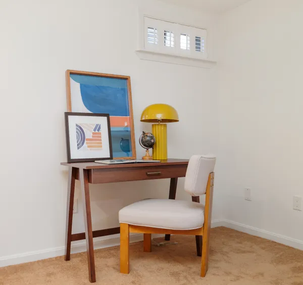 a view of a workspace with furniture