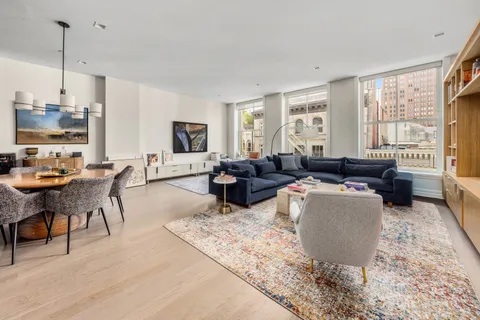 a living room with furniture flat screen tv and window