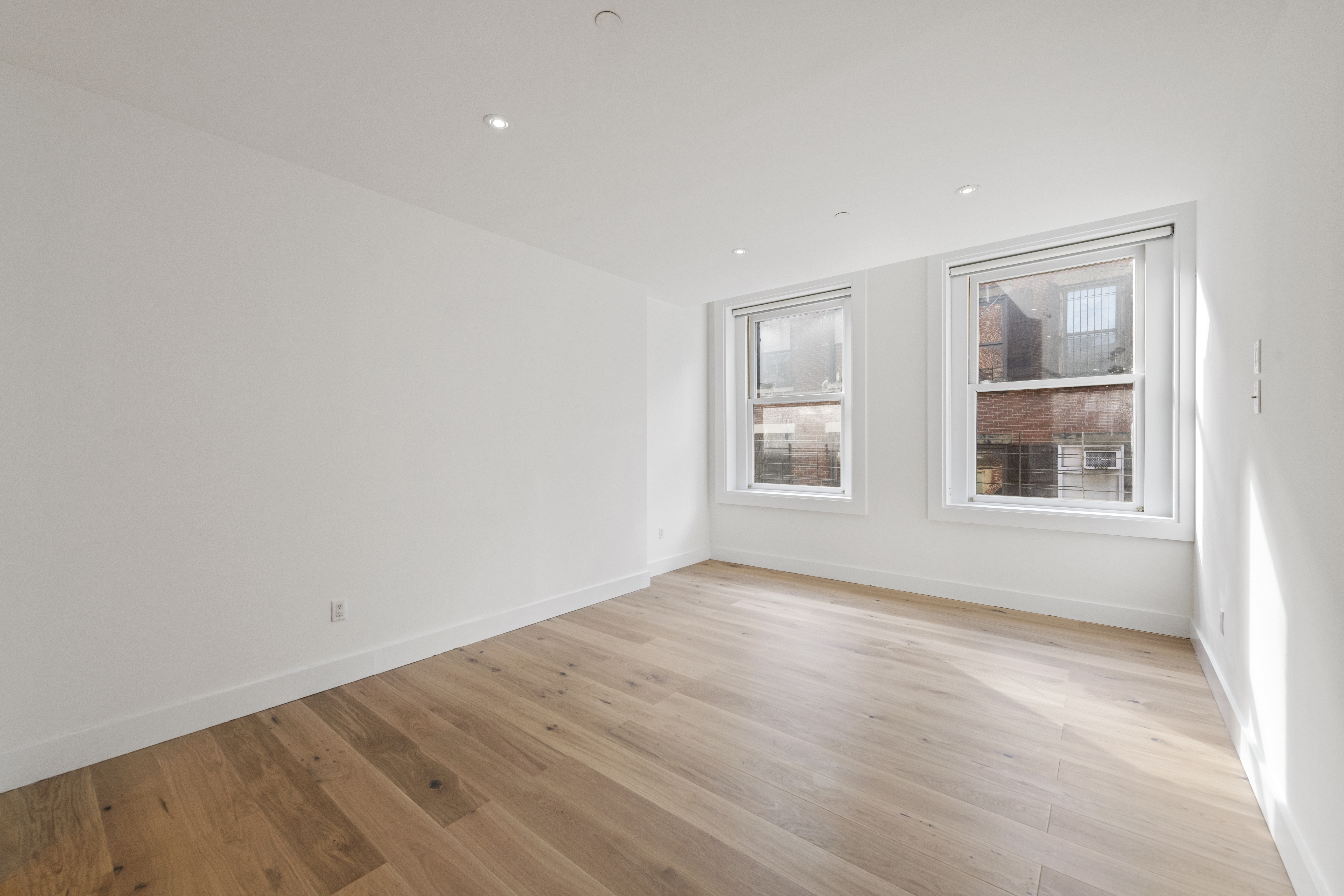 49 Walker Street, Unit PH Manhattan, NY 10013 - Photo 7 of 14 an empty room with wooden floor and windows