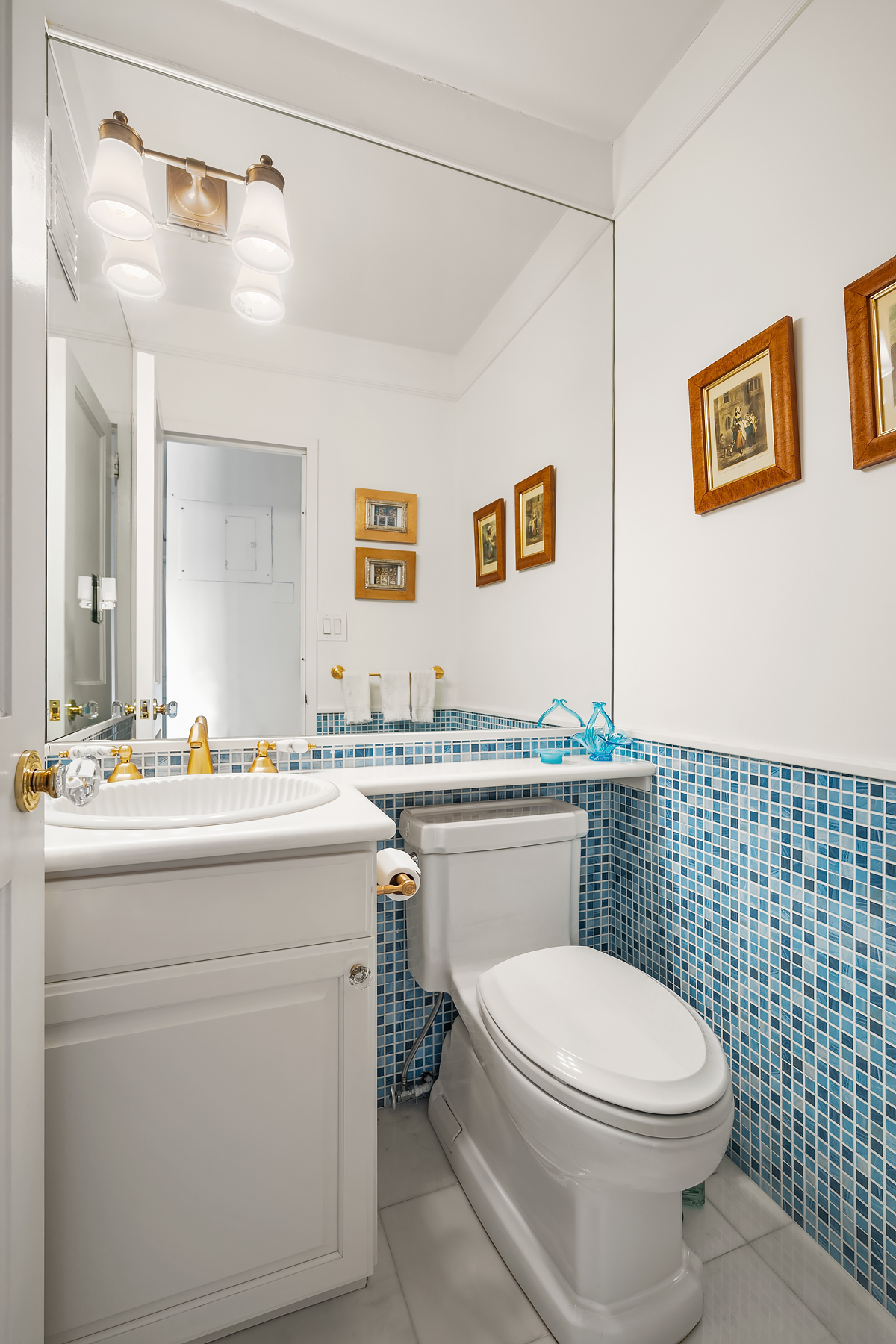 515 East 79th Street, Unit 15A Manhattan, NY 10075 - Photo 11 of 26 a bathroom with a granite countertop toilet sink and mirror