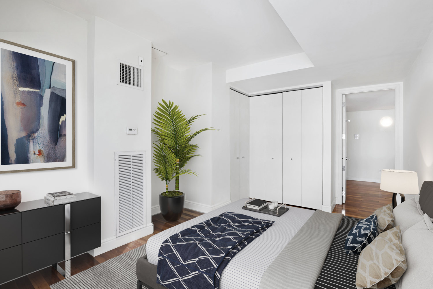 88 Greenwich Street, Unit 1023 Manhattan, NY 10006 - Photo 4 of 20 a bedroom with a bed and a potted plant