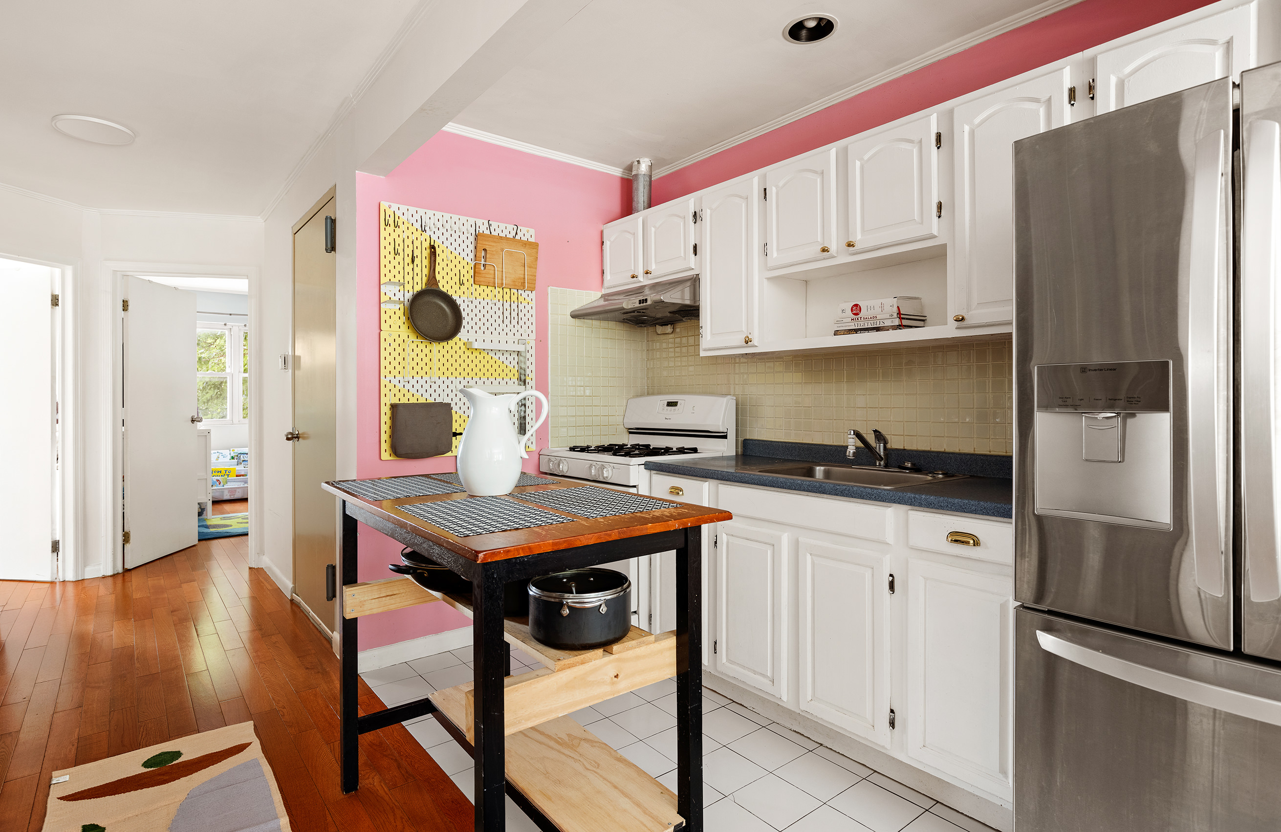 1427 Greene Avenue, Unit 2 Brooklyn, NY 11237 - Photo 4 of 9 a kitchen with stainless steel appliances granite countertop a refrigerator a sink dishwasher and white cabinets next to a window