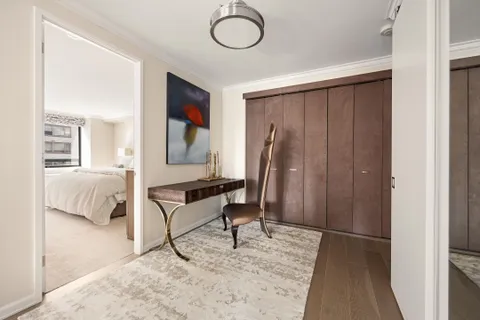 a living room with furniture a desk and chair with wooden floor