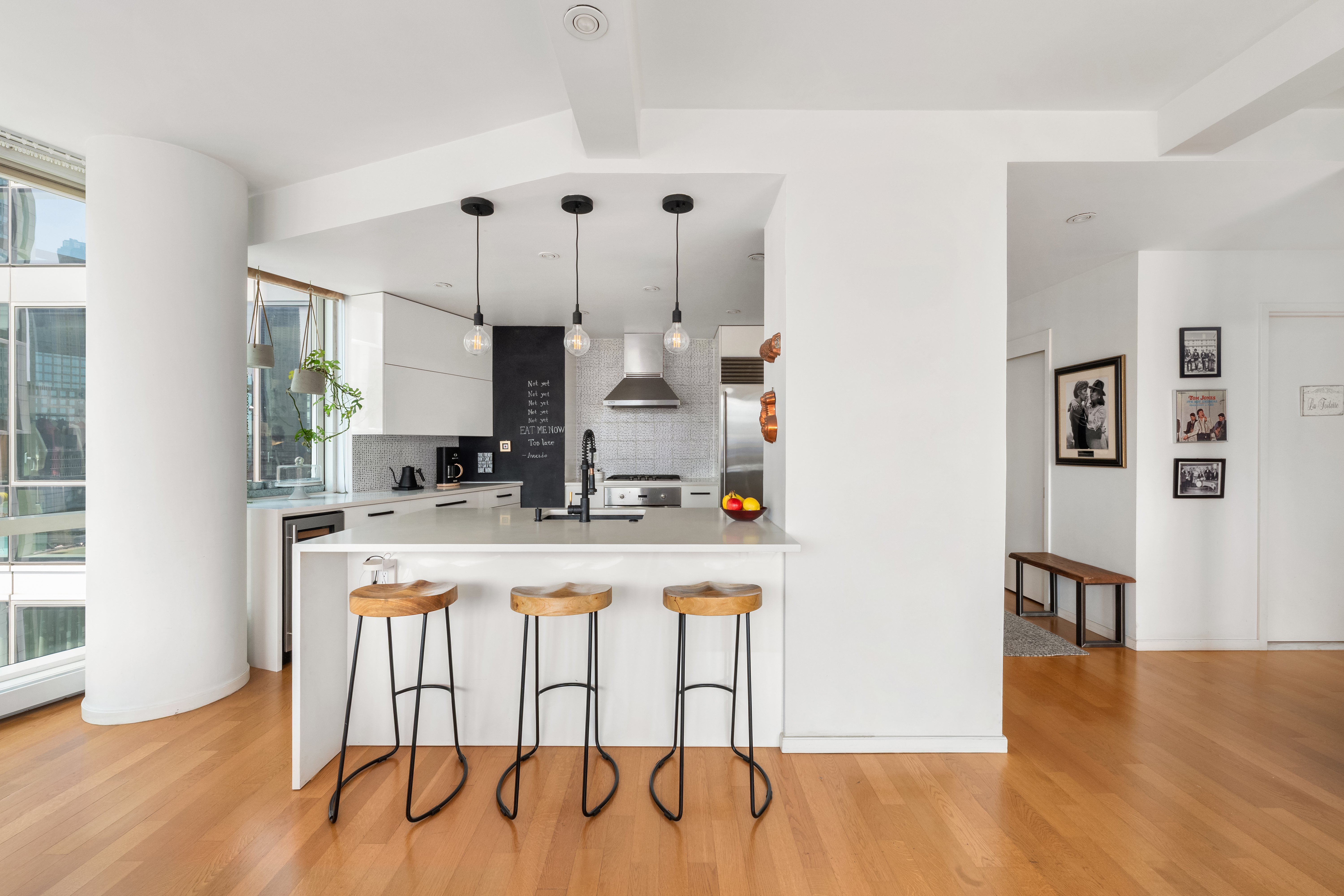200 Chambers Street, Unit 25F Manhattan, NY 10007 - Photo 5 of 13 a kitchen with kitchen island a white cabinets and chairs