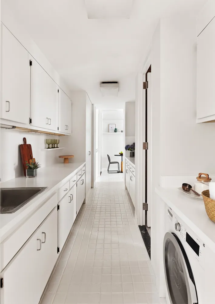 a view of a kitchen with sink washer and dryer