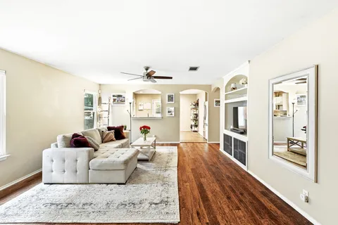 a living room with furniture and wooden floor