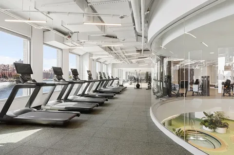 a living room with patio furniture and a floor to ceiling window