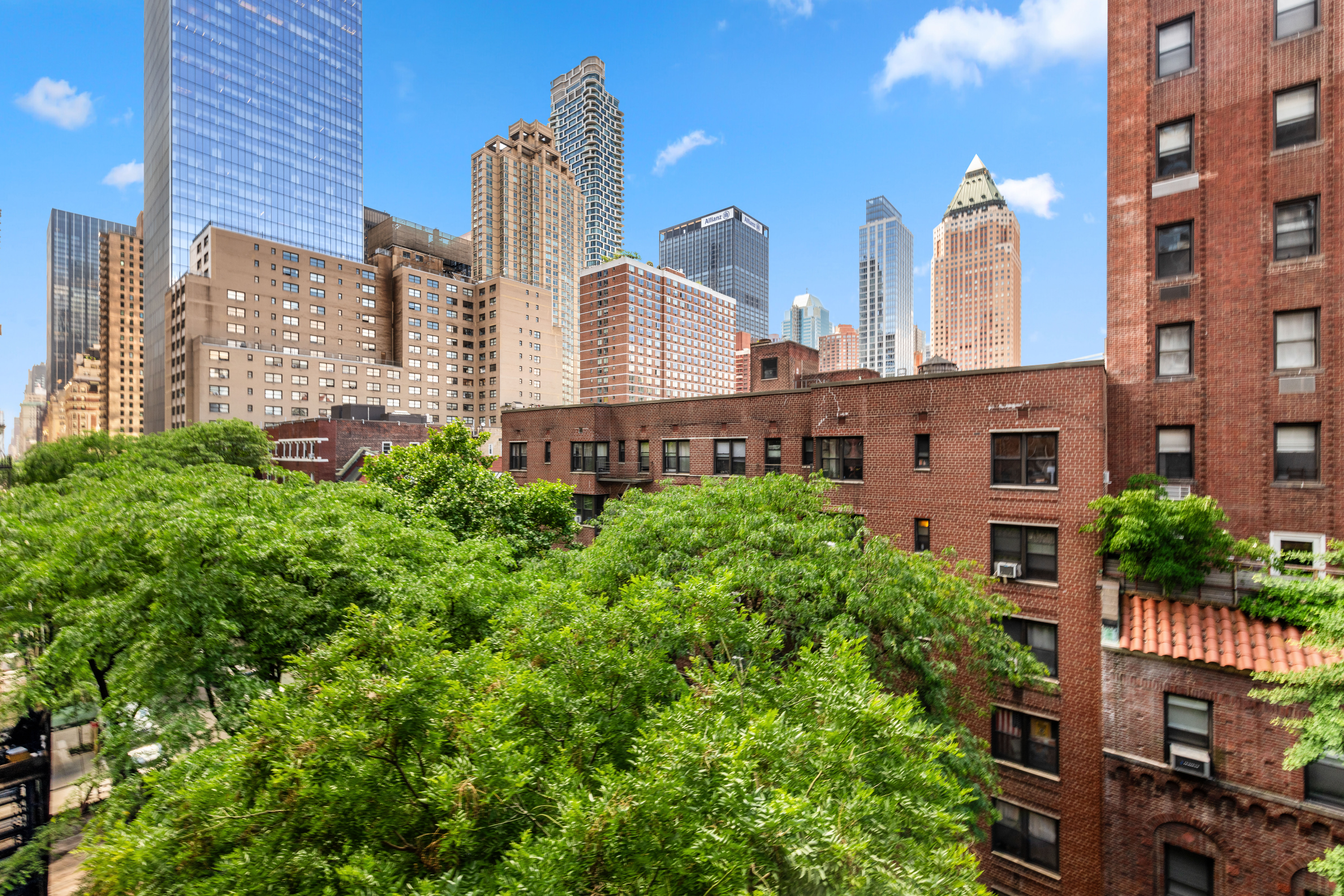 345 West 55th Street, Unit 6B Manhattan, NY 10019 - Photo 1 of 10 a front view of a multi story residential apartment building with a yard and outdoor seating