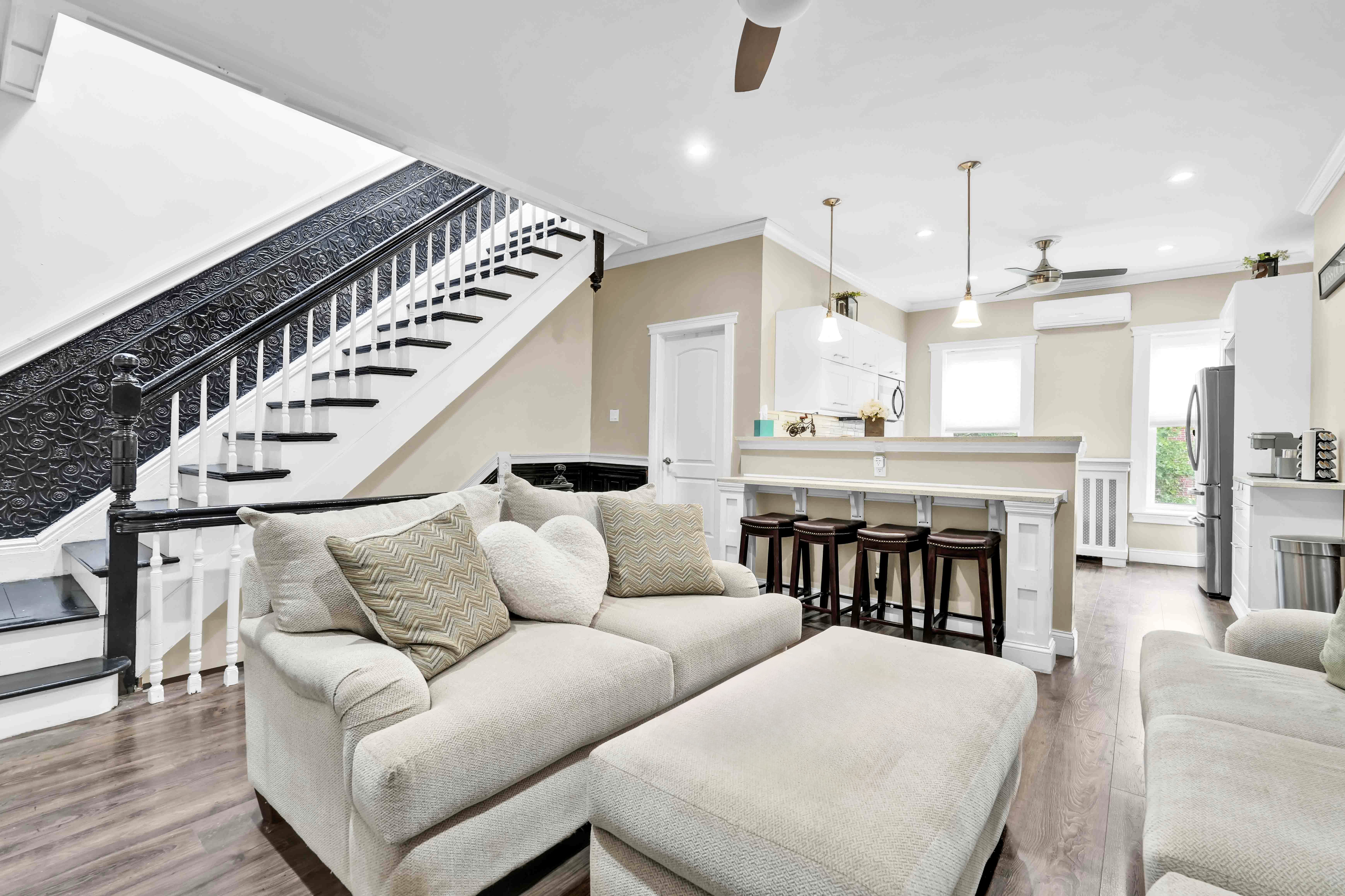 519 Monroe Street Brooklyn, NY 11221 - Photo 8 of 55 a living room with furniture kitchen view and a chandelier