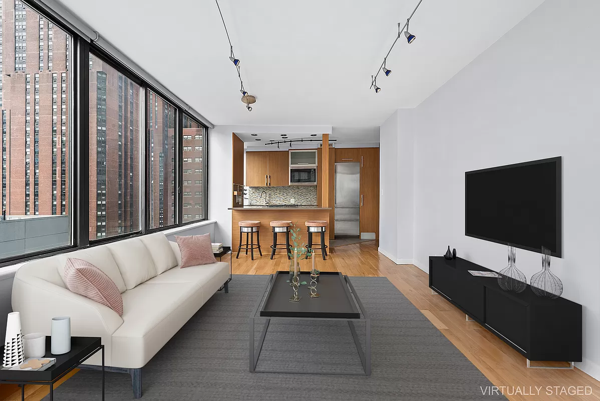300 East 93rd Street, Unit 14F Manhattan, NY 10128 - Photo 3 of 14 a living room with furniture and a flat screen tv