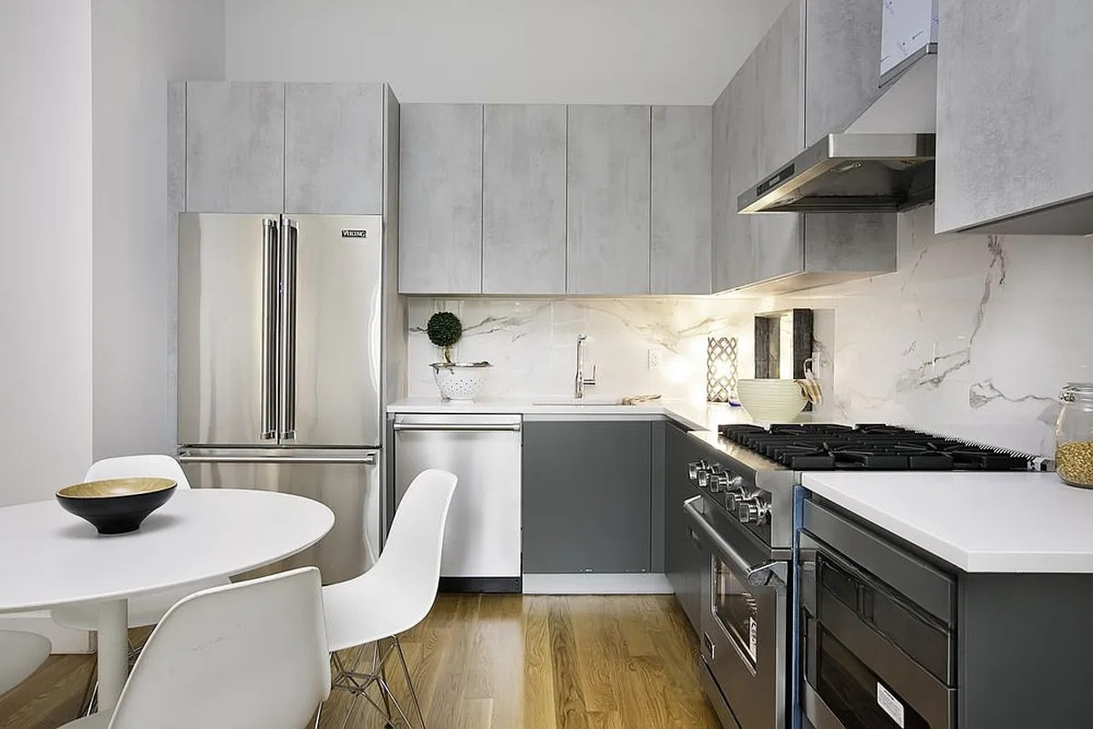 222 Withers Street, Unit 2A Brooklyn, NY 11211 - Photo 4 of 11 a kitchen with stainless steel appliances a stove a sink a refrigerator a table and chairs