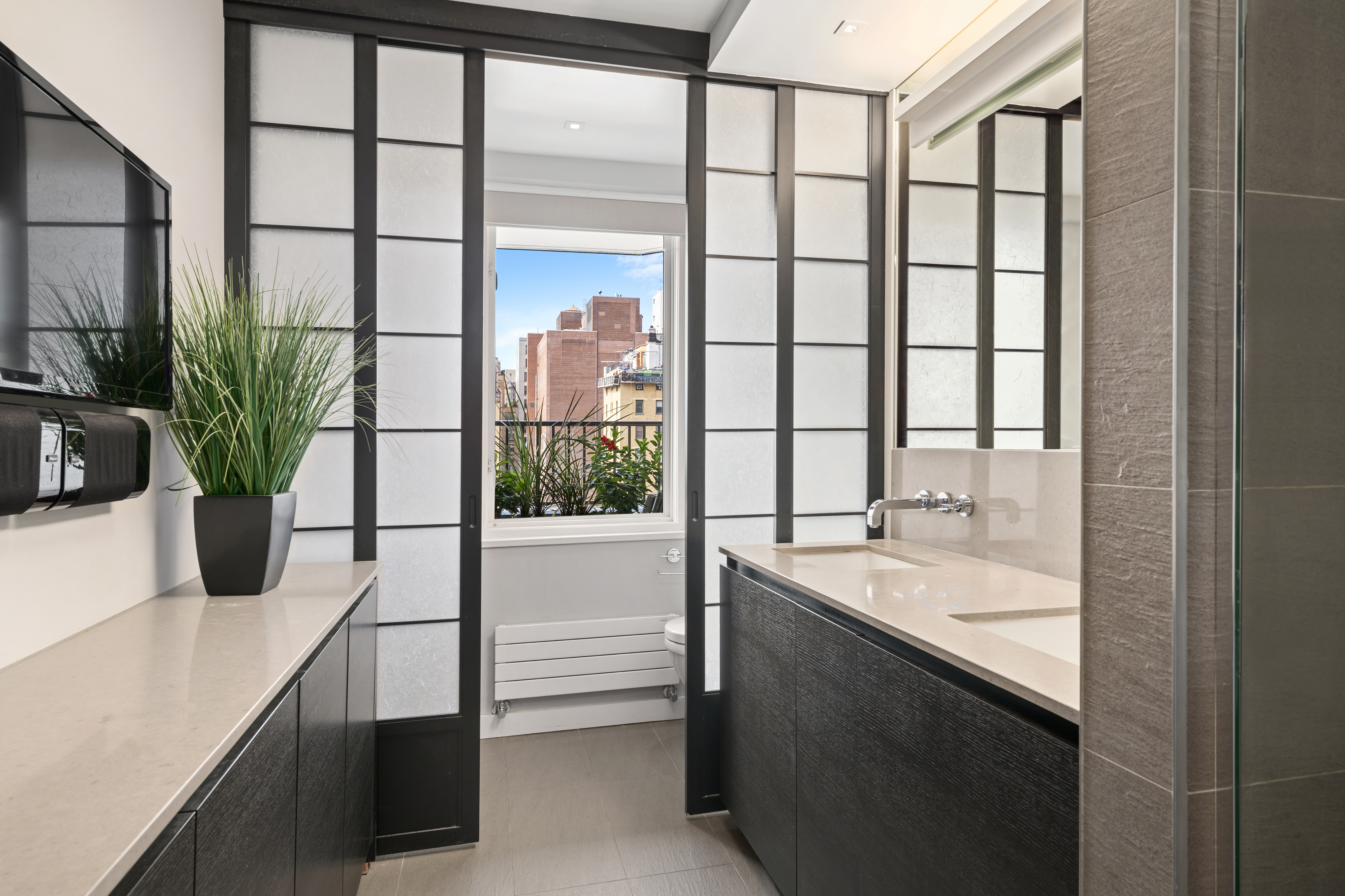 301 East 78th Street, Unit 16EF Manhattan, NY 10075 - Photo 7 of 12 a bathroom with a granite countertop sink and a large window