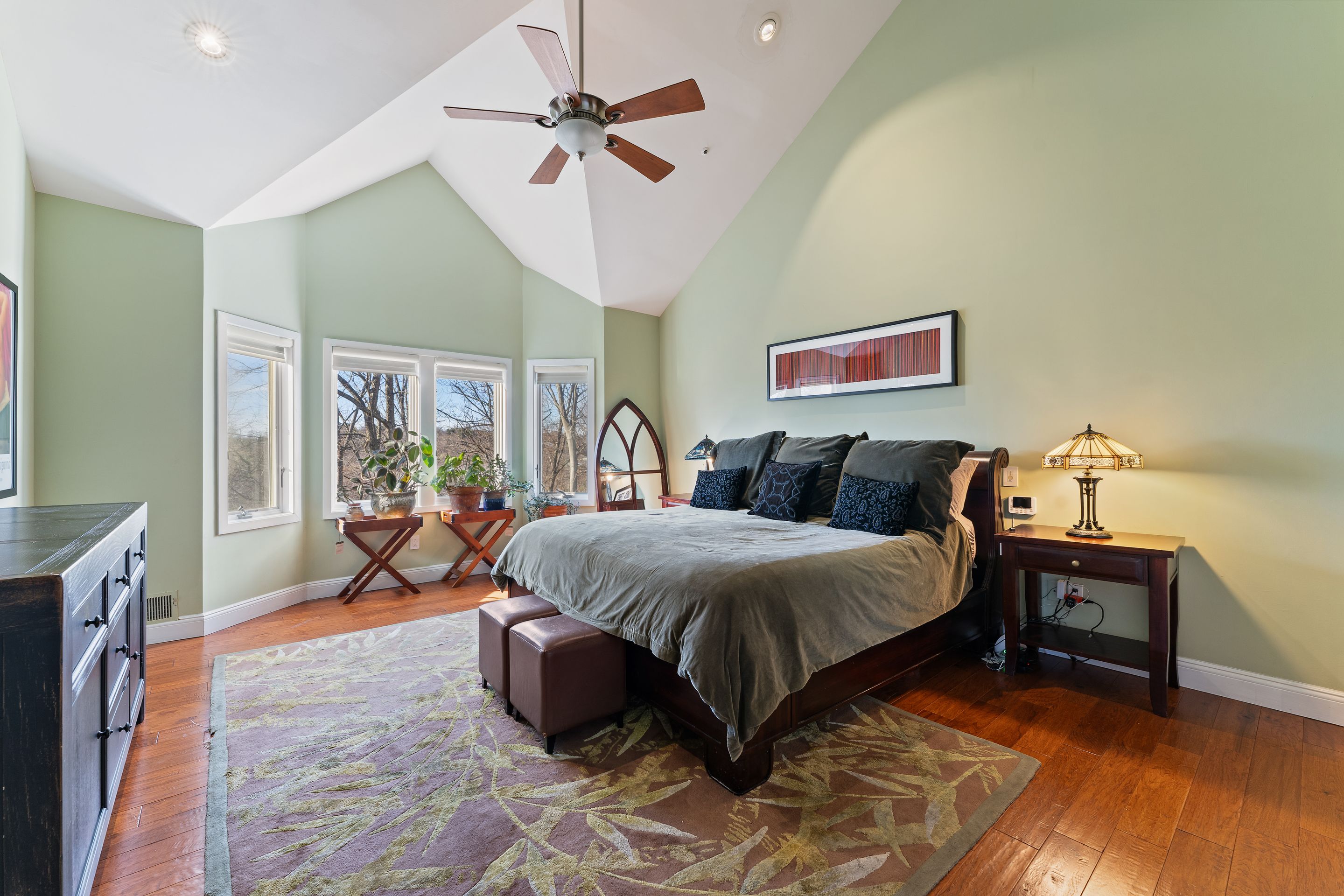 124 Boulder Ridge Road Scarsdale, NY 10583 - Photo 10 of 31 a spacious bedroom with a large bed and a chandelier