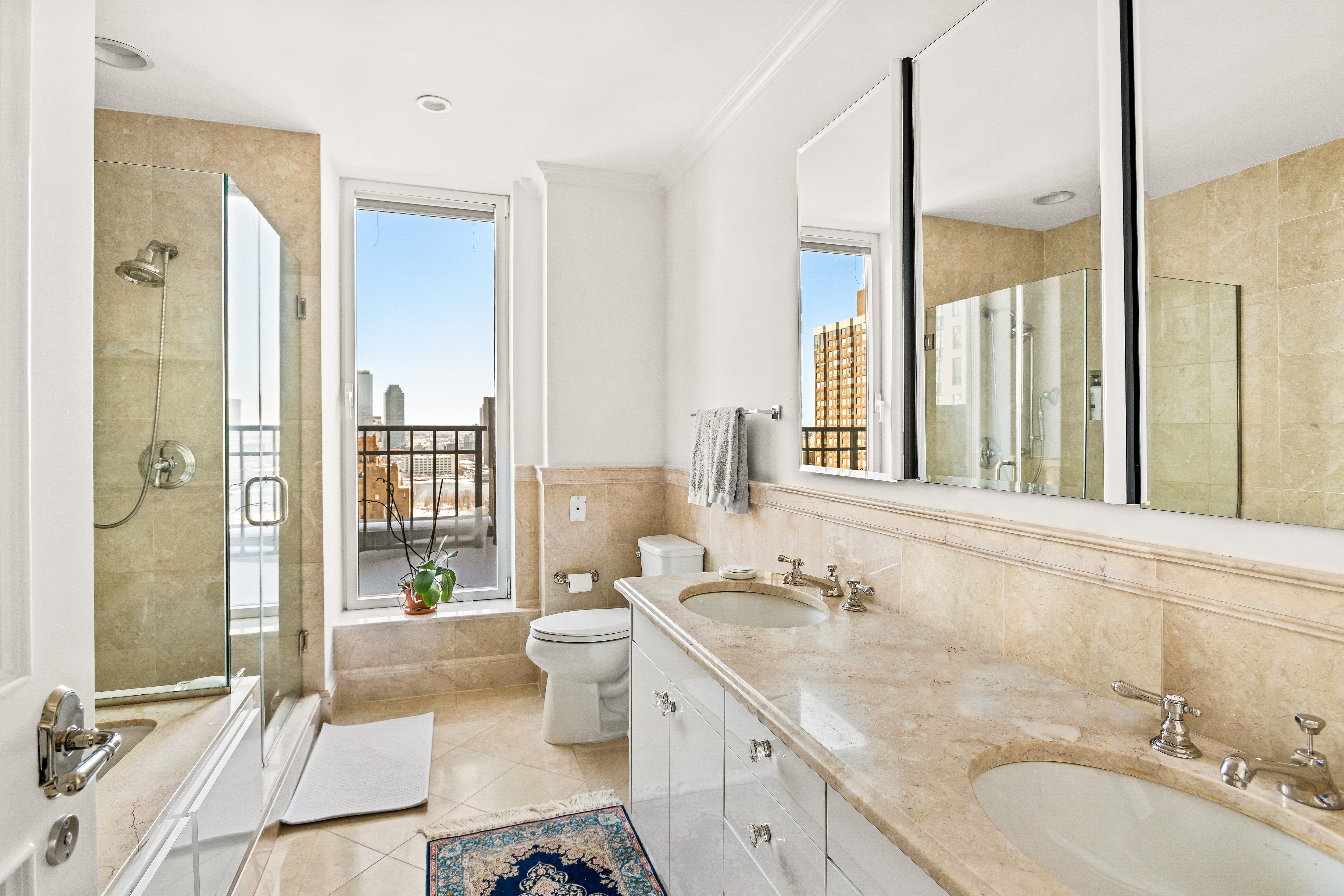 351 East 51st Street, Unit PH7A Manhattan, NY 10022 - Photo 5 of 14 a bathroom with a granite countertop sink toilet and shower