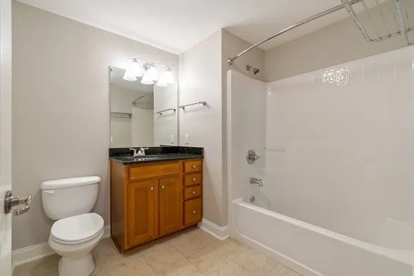 a bathroom with a granite countertop toilet sink and shower