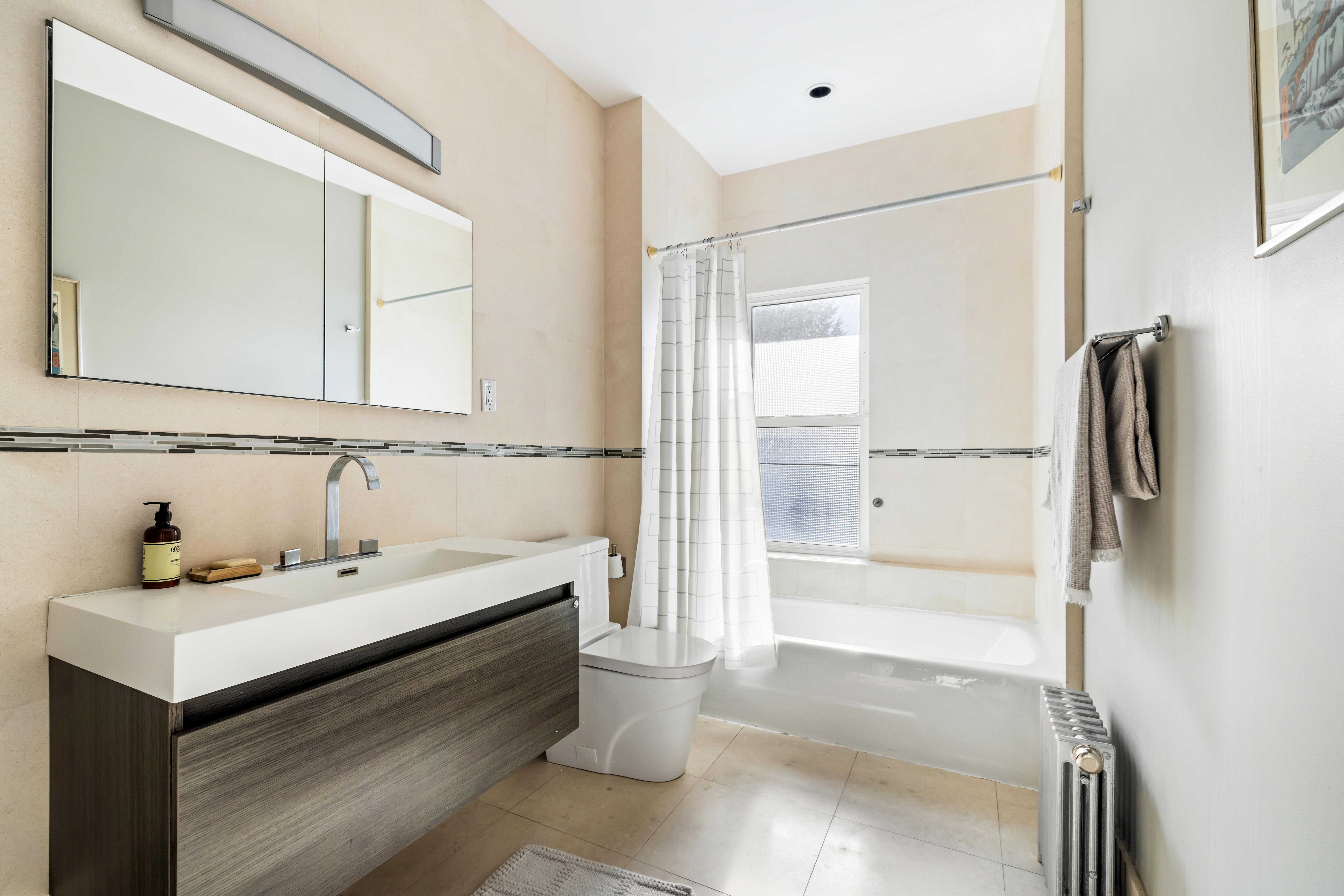 226 11th Street, Unit 2 Brooklyn, NY 11215 - Photo 13 of 19 a bathroom with a sink and a mirror